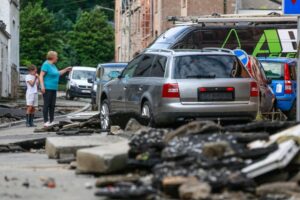 Rainwater gushing down steep streets swept away dozens of cars.