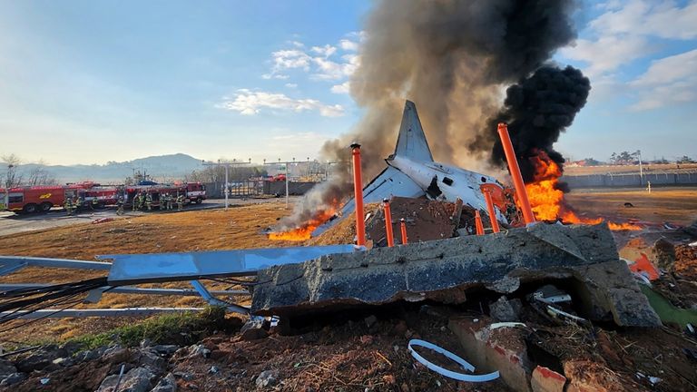 The passenger plane in flames in the immediate aftermath of the crash.
Pic: South Korea's Muan Fire Station/AP